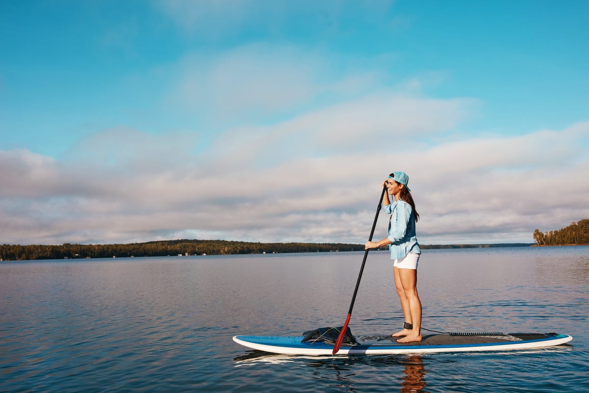 A picture of a young woman riding on a lake