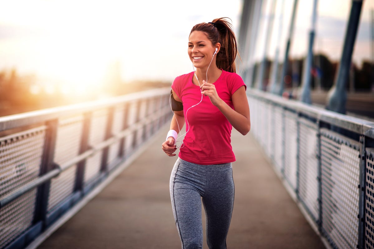 a young woman running out on a bridge.